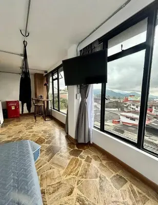 a bedroom with a large window with a view at Open Sky in Manizales