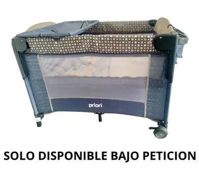a baby crib with a bed in a suitcase at Open Sky in Manizales