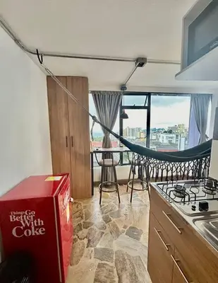 a kitchen with a stove and a table with a box at Open Sky in Manizales