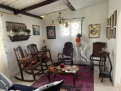 a living room with chairs and a couch and a table at Encanto Verde in Rionegro