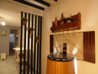 a room with a bar with wine glasses on the wall at Hospedaje J&L in Medellín