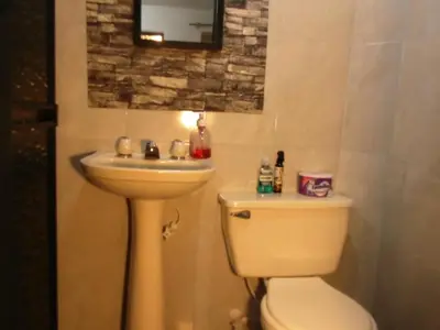 a bathroom with a toilet and a sink at Hospedaje J&L in Medellín