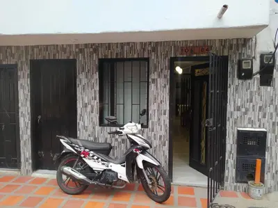 a motorcycle parked in front of a building at Hospedaje J&L in Medellín