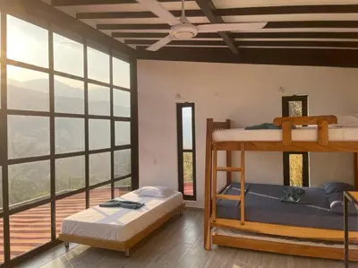 a bedroom with two bunk beds and a balcony at Finca cerca a Medellín Villa Cerat in Sopetran