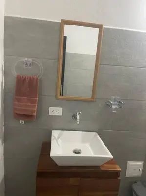 a bathroom with a white sink and a mirror at Finca cerca a Medellín Villa Cerat in Sopetran