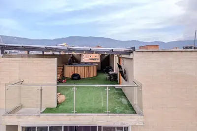 a rooftop patio with a table on top of a building at Apartamento en Laureles con piscina y parquedero 802 in Medellín