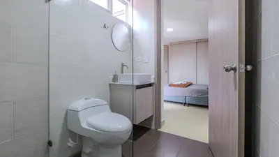 a bathroom with a white toilet and a sink at Apartamento en Laureles con piscina y parquedero 802 in Medellín