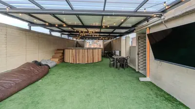 a large room with green carpet and a large screen at Apartamento en Laureles con piscina y parquedero 802 in Medellín