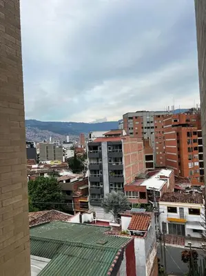a view of a city with buildings and mountains at Exclusivo apartamento con piscina y parqueadero 602 in Medellín