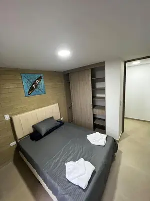 a bedroom with a bed with two towels on it at Exclusivo apartamento con piscina y parqueadero 602 in Medellín