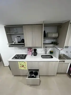 a small kitchen with a sink and a stove at Exclusivo apartamento con piscina y parqueadero 602 in Medellín