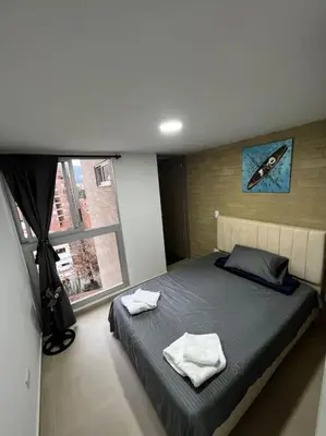a bedroom with a bed with two towels on it at Exclusivo apartamento con piscina y parqueadero 602 in Medellín