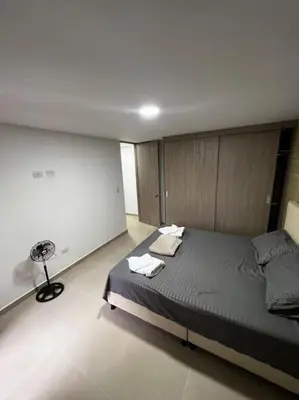 a bedroom with a large bed in a room at Exclusivo apartamento con piscina y parqueadero 602 in Medellín