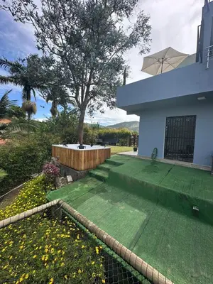 a backyard of a house with a grass yard at Cabaña333 in Guatapé