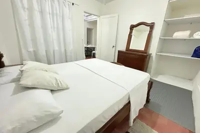 a bedroom with a bed and a mirror and shelves at HOSPEDAJE LAURa in Medellín