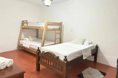 two bunk beds in a room with a table at HOSPEDAJE LAURa in Medellín