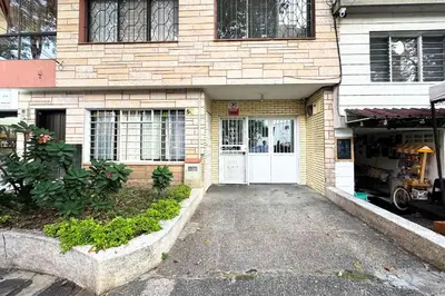 a brick house with a white door and a driveway at HOSPEDAJE LAURa in Medellín