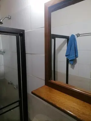a mirror in a bathroom next to a shower at Cuarto con cuarto de baño y terraza in Medellín