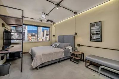 a bedroom with a bed and a view of a city at Nutibara Express By HOUSY in Medellín