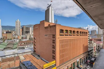 a large brick building with a tall tower on top at Nutibara Express By HOUSY in Medellín