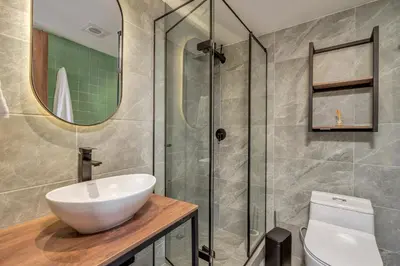 a bathroom with a sink and a glass shower at Nutibara Express By HOUSY in Medellín