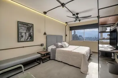 a bedroom with a bed and a window at Nutibara Express By HOUSY in Medellín