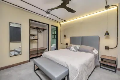 a bedroom with a bed and a ceiling fan at Nutibara Express By HOUSY in Medellín