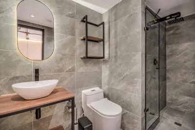 a bathroom with a toilet and a sink and a mirror at Nutibara Express By HOUSY in Medellín