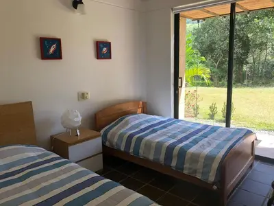 a bedroom with two beds and a window at Finca La Siria vista Cerro Tusa in Amagá