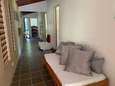 a living room with a couch with pillows on it at Finca La Siria vista Cerro Tusa in Amagá