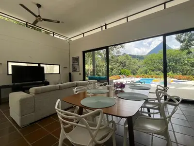 a living room with a table and chairs and a couch at Finca La Siria vista Cerro Tusa in Amagá