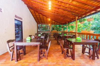 a dining room with wooden tables and chairs at Hotel Tropical San Jeronimo in San Jerónimo