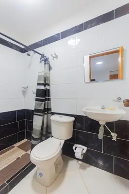 a bathroom with a toilet and a sink at Hotel Tropical San Jeronimo in San Jerónimo