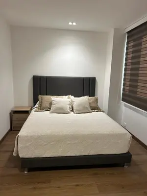 a bed with a black headboard in a bedroom at Acogedor Apto a pasos del metro de Medellín zona centro in Medellín