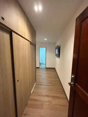 an empty hallway with a door leading to a room at Acogedor Apto a pasos del metro de Medellín zona centro in Medellín