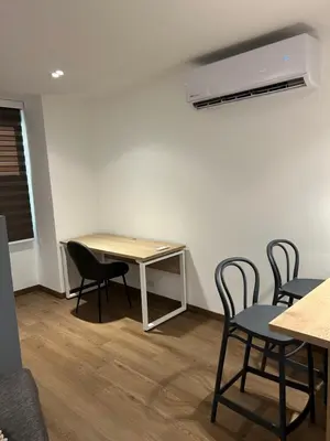 a room with chairs and a table and a heater at Acogedor Apto a pasos del metro de Medellín zona centro in Medellín
