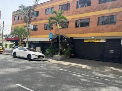 a white car parked in front of a building at Hotel JC 43 in Medellín