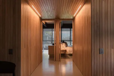 a hallway leading to a bedroom with a bed at Zeta Erre Apartments in Medellín