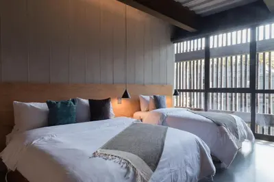 a bedroom with two beds and a large window at Zeta Erre Apartments in Medellín