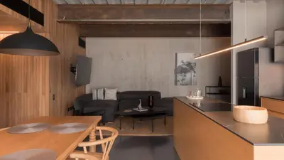 a kitchen and a living room with a table at Zeta Erre Apartments in Medellín