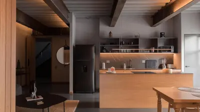 a kitchen with a black refrigerator and a table at Zeta Erre Apartments in Medellín