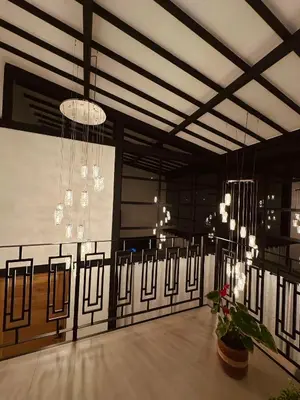 a room with chandeliers and a table with plants at Fénix in Marinilla