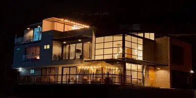 a large building with lights on it at night at Fénix in Marinilla