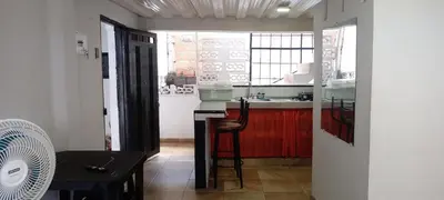 a kitchen with a counter and a sink and a table at La Posada De Shaz En Norcasia in Norcasia