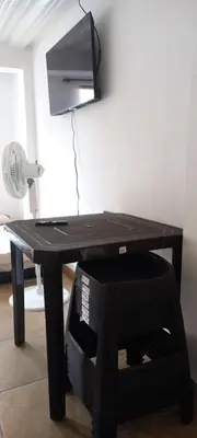 a black ping pong table with a fan at La Posada De Shaz En Norcasia in Norcasia