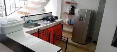 a small kitchen with a sink and a refrigerator at La Posada De Shaz En Norcasia in Norcasia