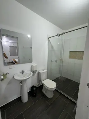 a bathroom with a toilet and a sink and a shower at Hotel FENIX in Doradal