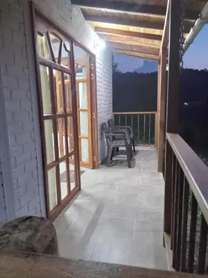 an open door to a balcony with a bench at Ancestral Cabaña in San Vicente
