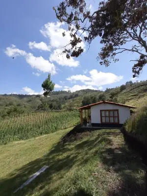 a small house in the middle of a field at Ancestral Cabaña in San Vicente