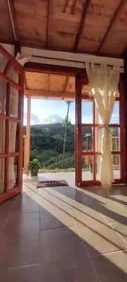 a room with a large glass door with a view at Ancestral Cabaña in San Vicente